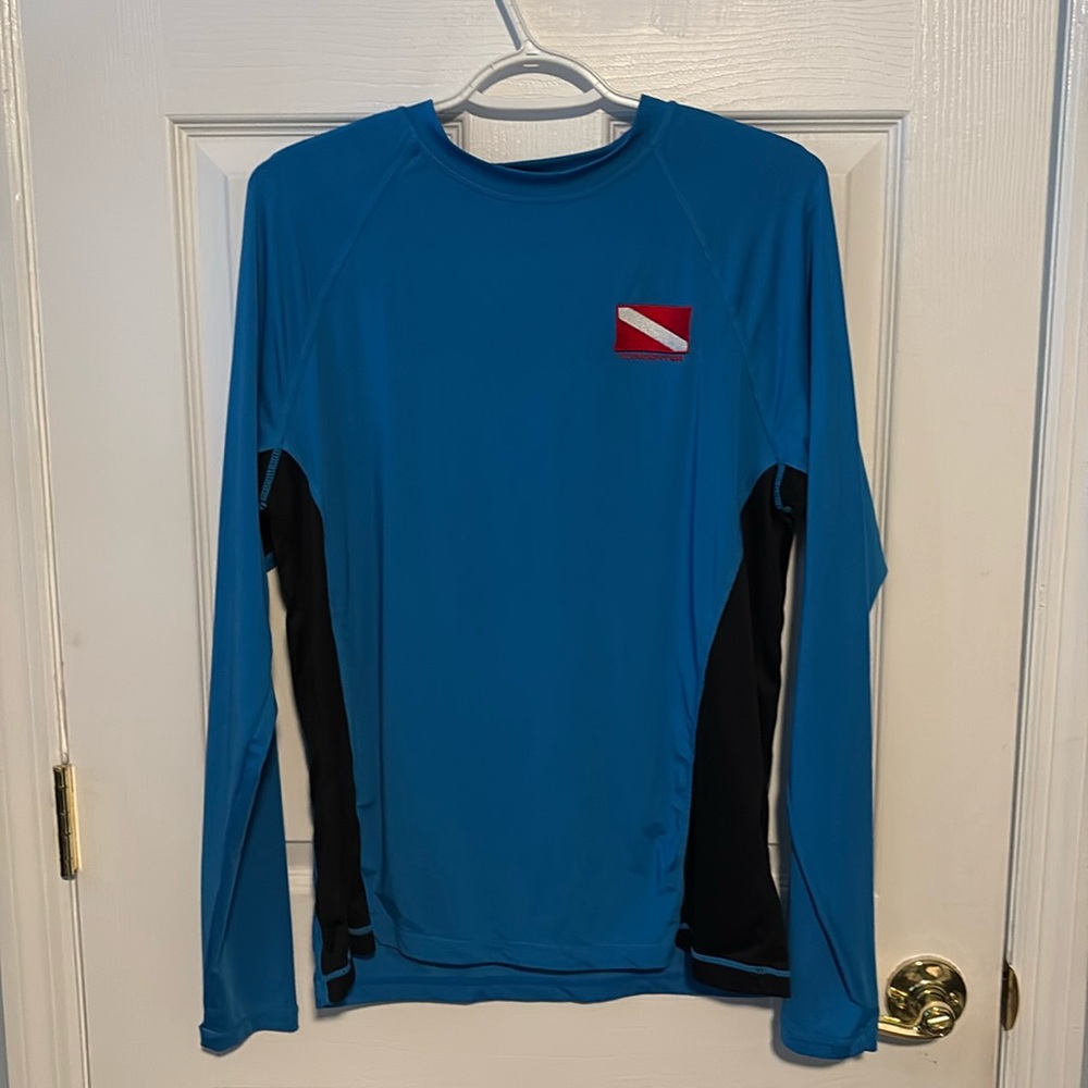 Women’s Large shirt by HUK Tormenter Fishing Products. Worn as dive shirt.